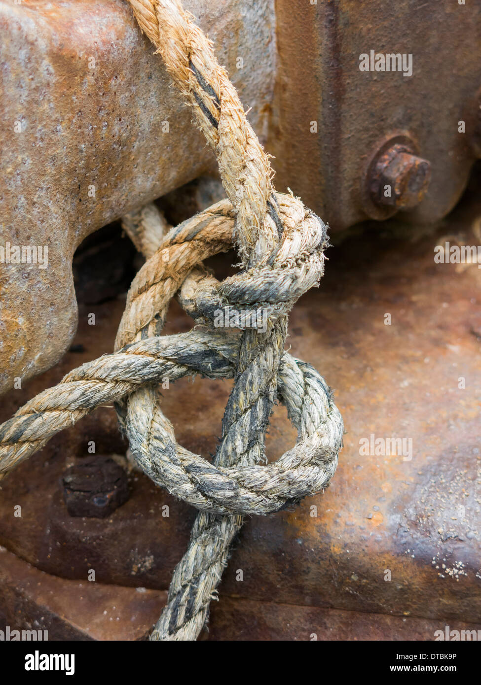 rope knot tied to piece of metal machinery England Stock Photo