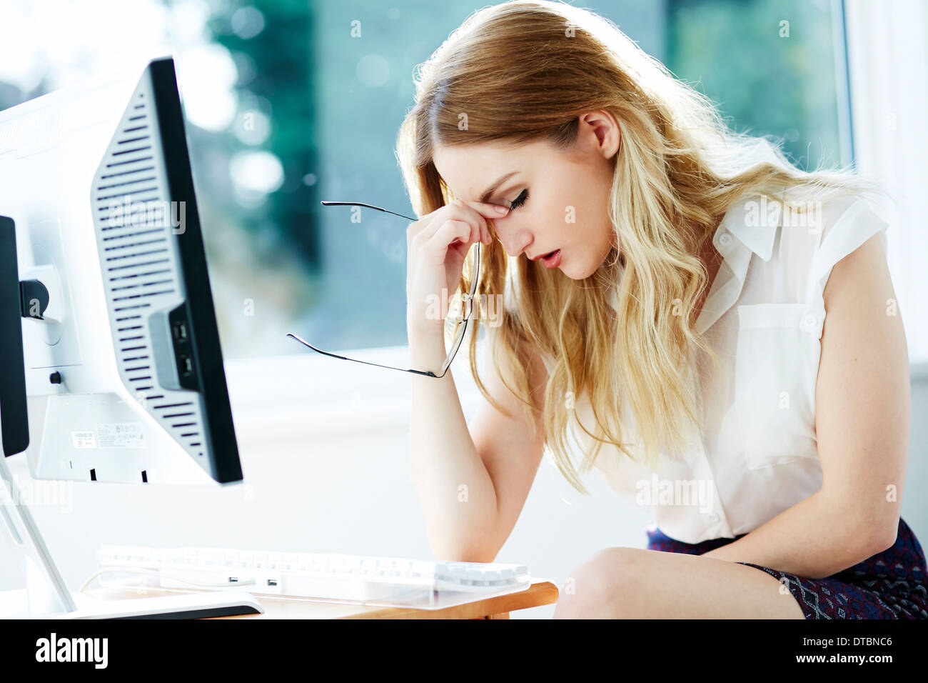 Girl stressed at work Stock Photo