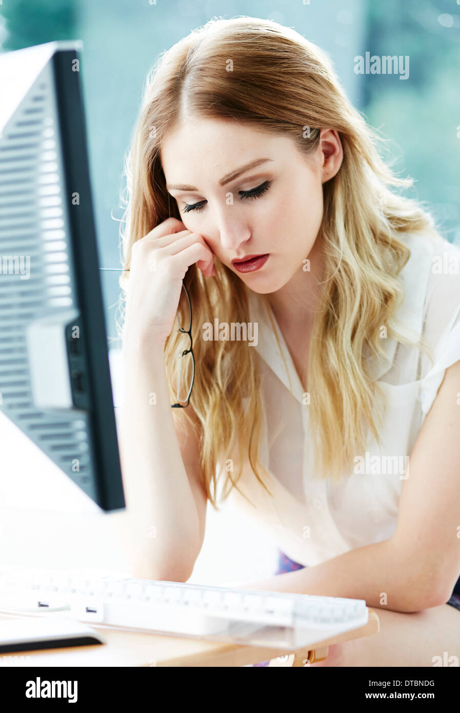 Girl stressed at work Stock Photo