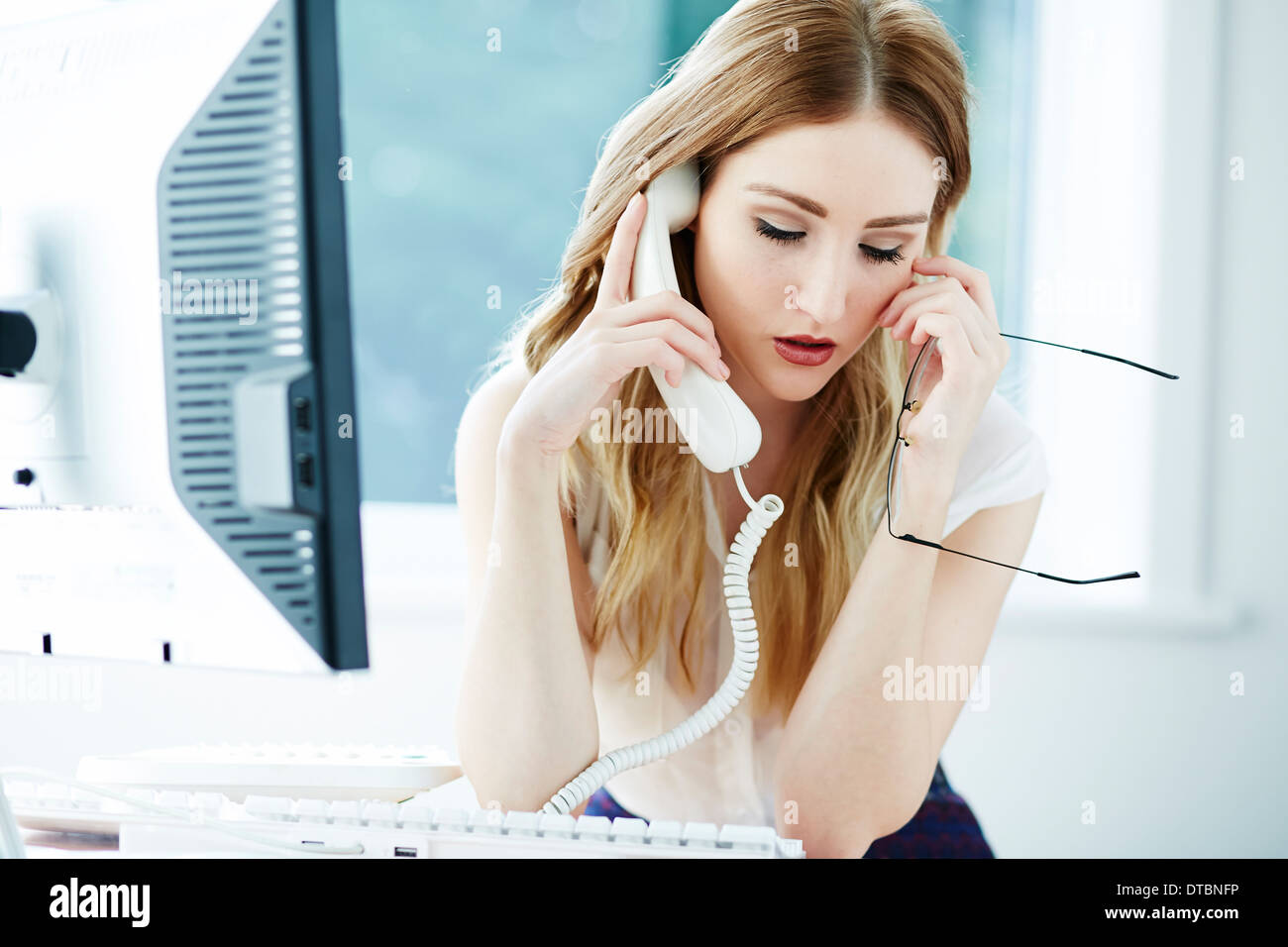 Girl stressed at work Stock Photo