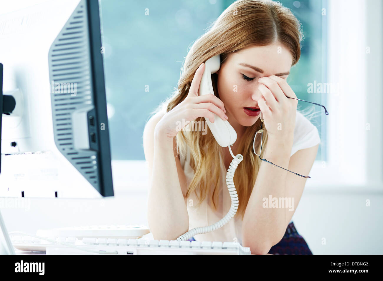 Girl stressed at work Stock Photo