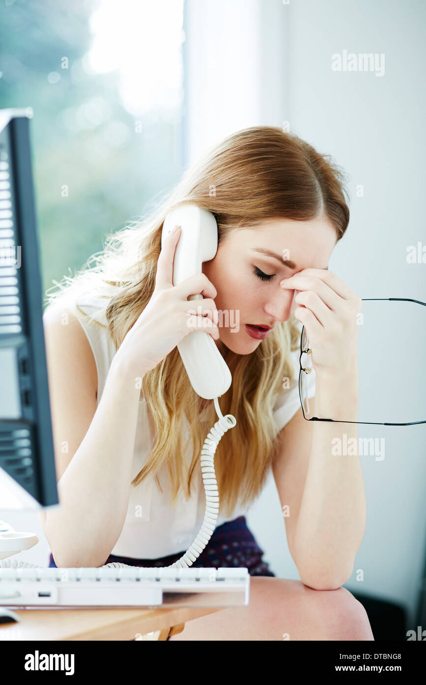 Girl stressed at work Stock Photo