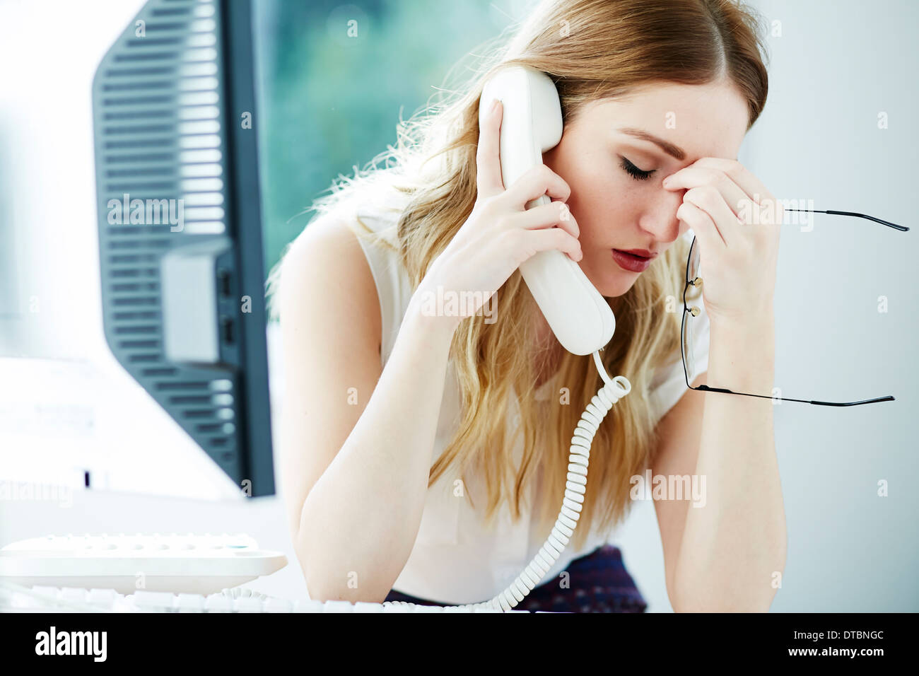 Girl stressed at work Stock Photo