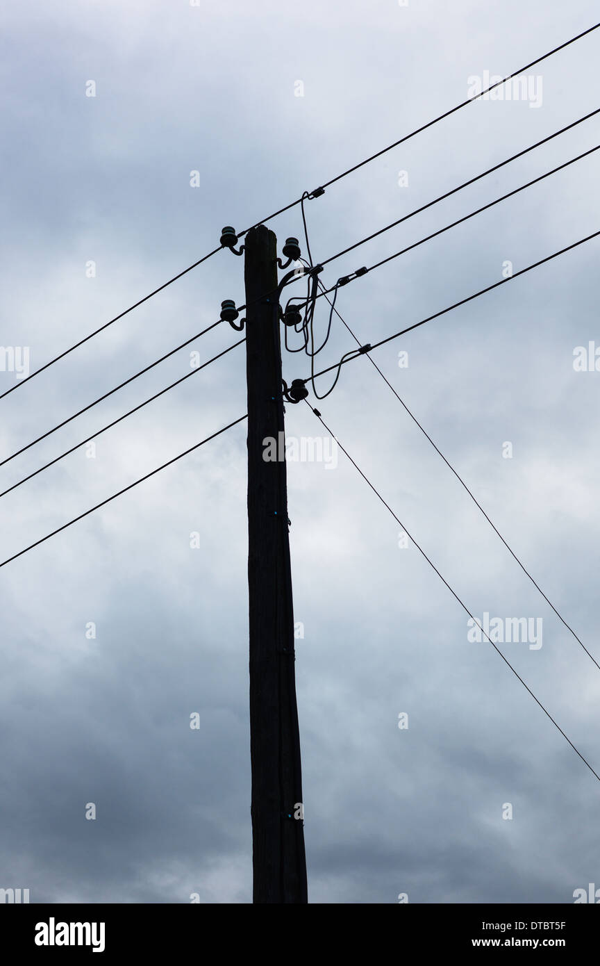 Electricity pylon against cloudy sky Stock Photo - Alamy