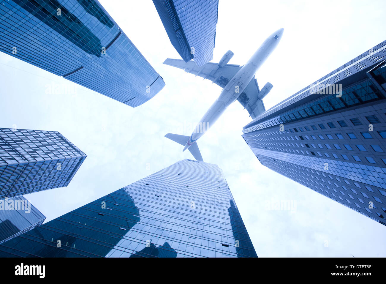 Airplane Flying Over High Buildings High Resolution Stock Photography