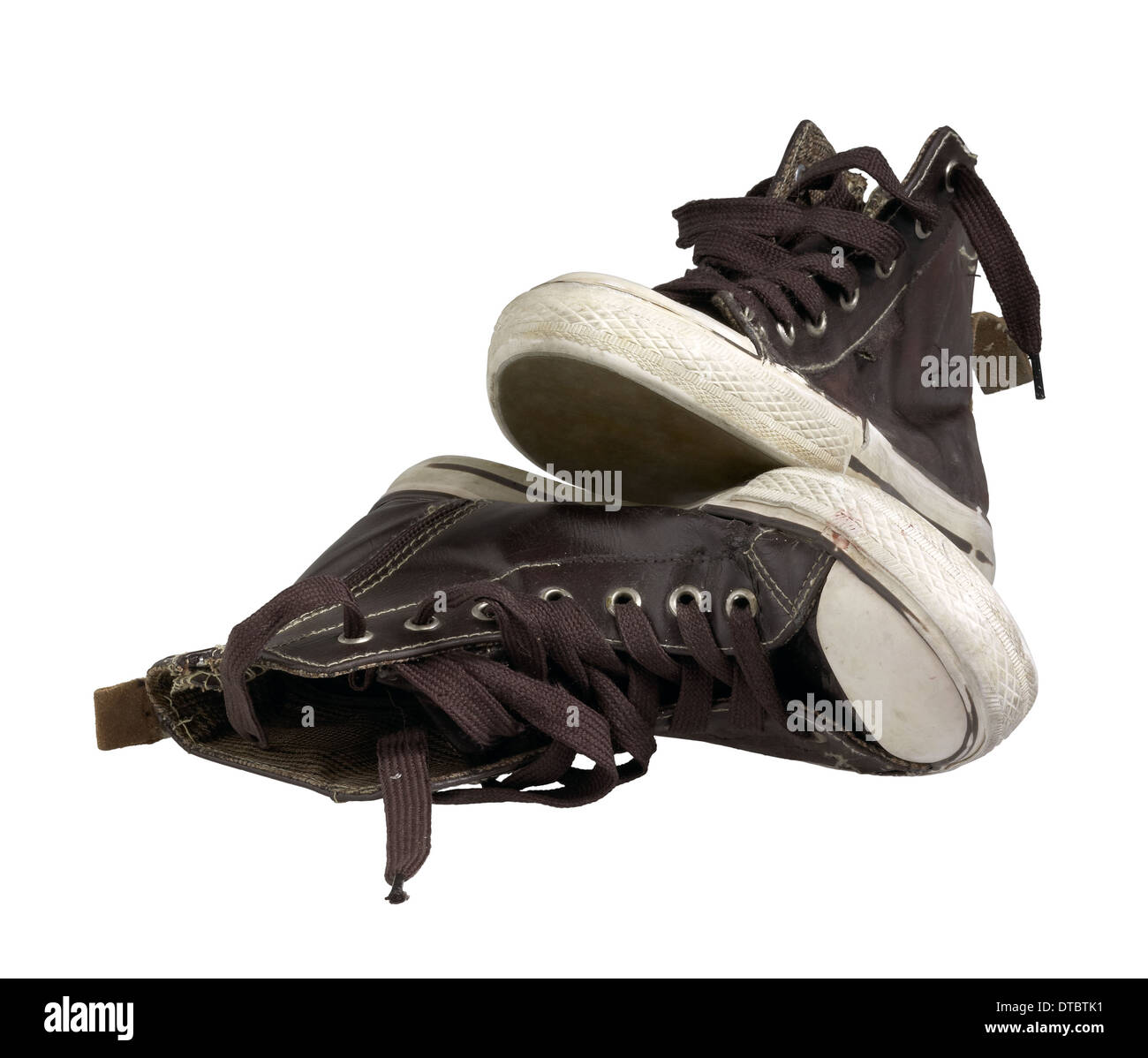 a pair of old brown sneakers in white back Stock Photo