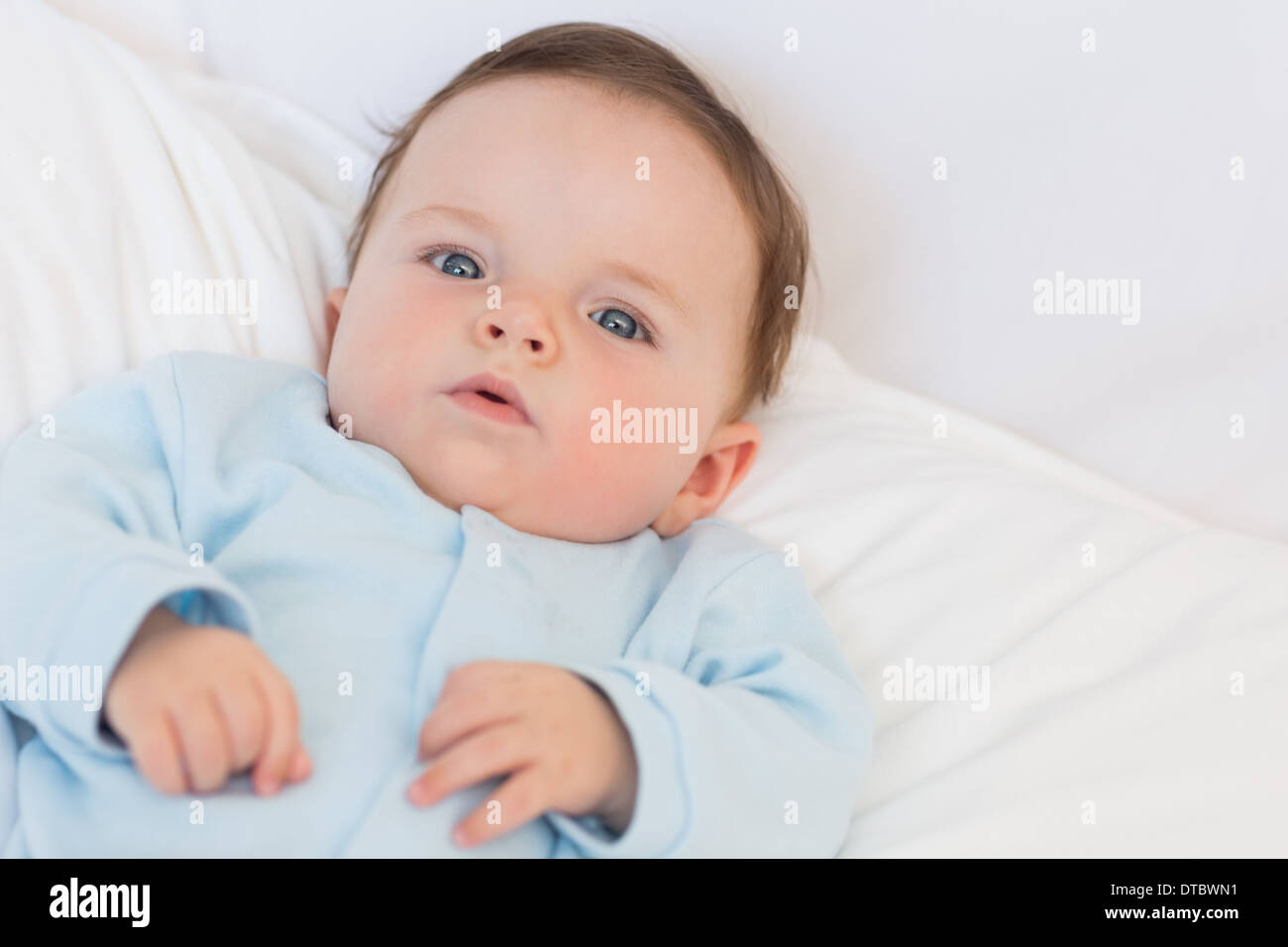 Portrait of adorable baby in bed Stock Photo