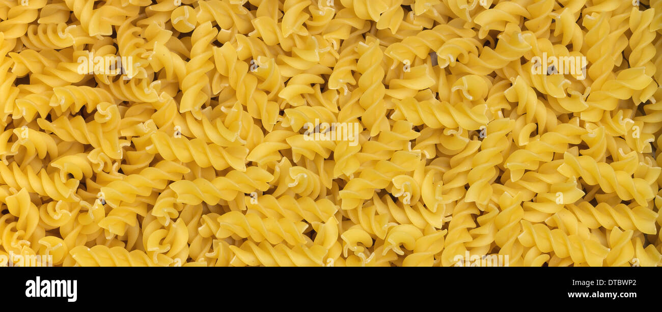 Download Full Frame Background With Lots Of Yellow Fusilli Noodles Stock Photo Alamy Yellowimages Mockups