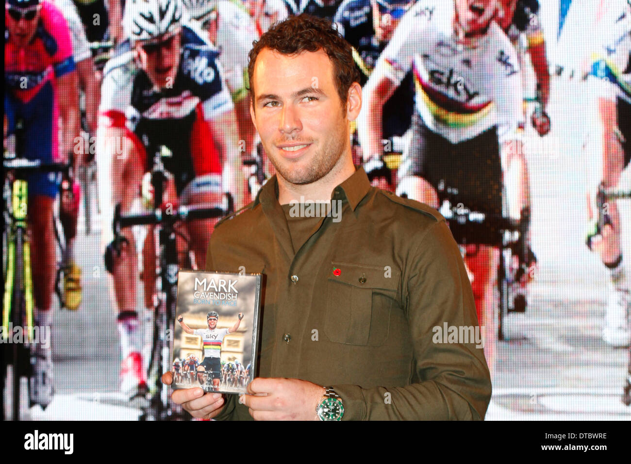 Mark Cavendish poses for a photograph during a signing event to his new