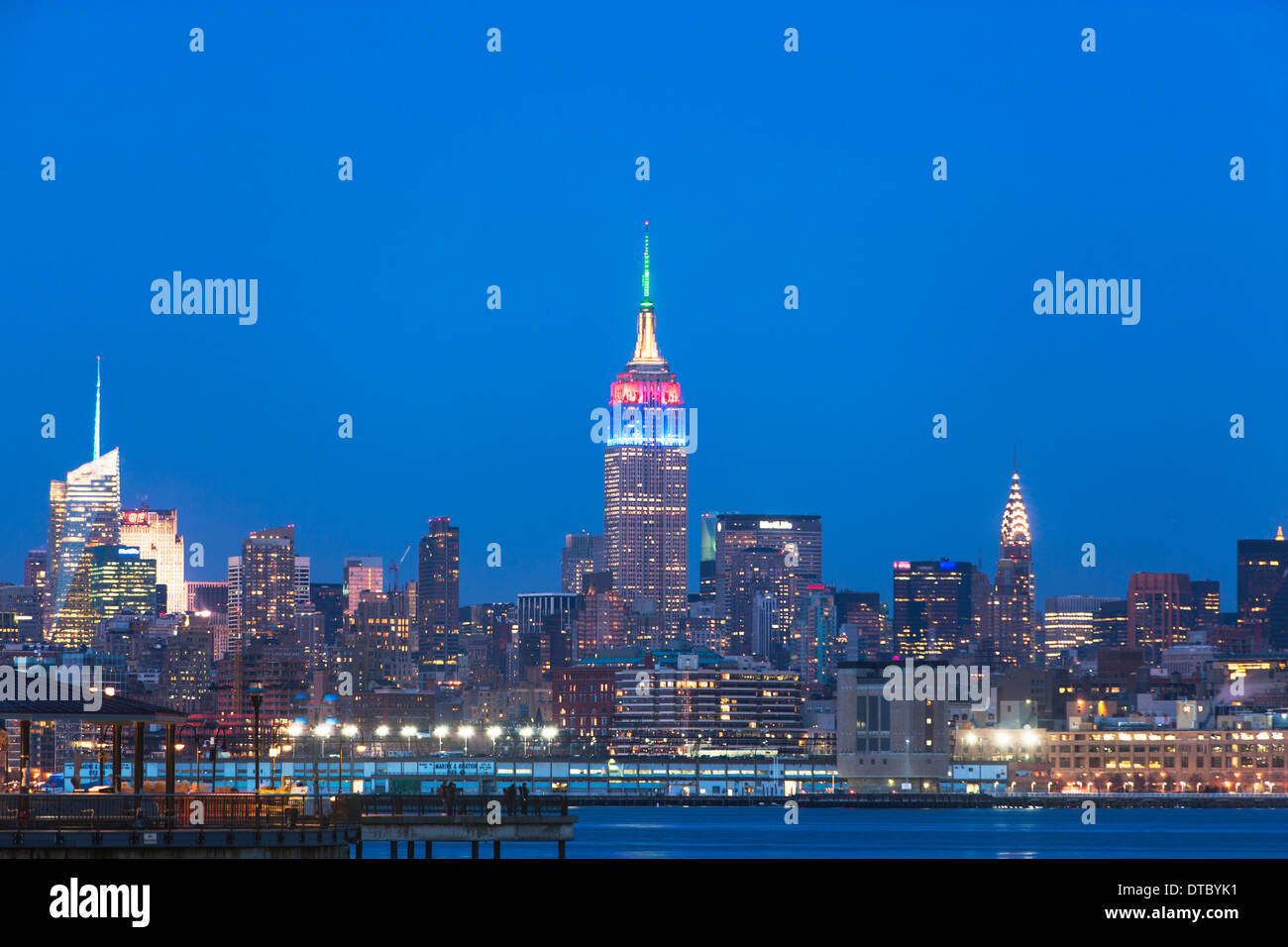 View of waterfront and New York skyline at dusk Stock Photo