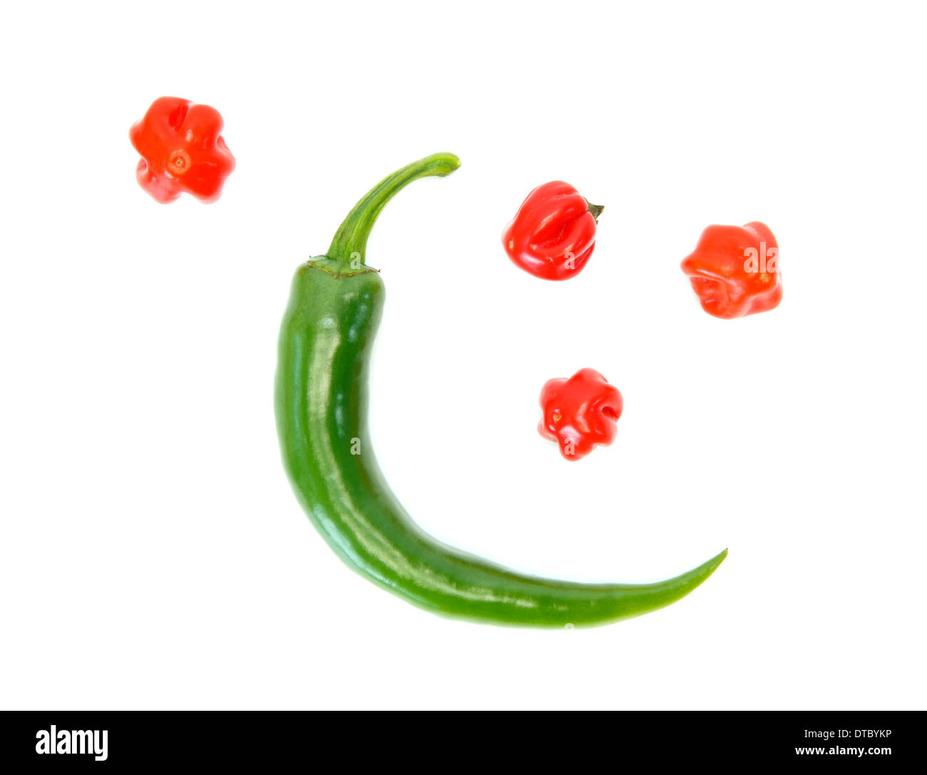 Two different kinds of peppers as the moon and the stars against white background Stock Photo