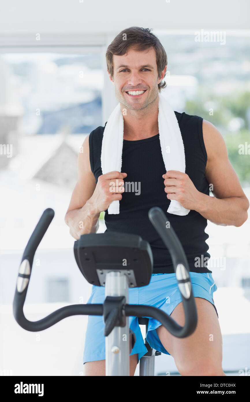 Smiling man working out at spinning class in bright gym Stock Photo - Alamy