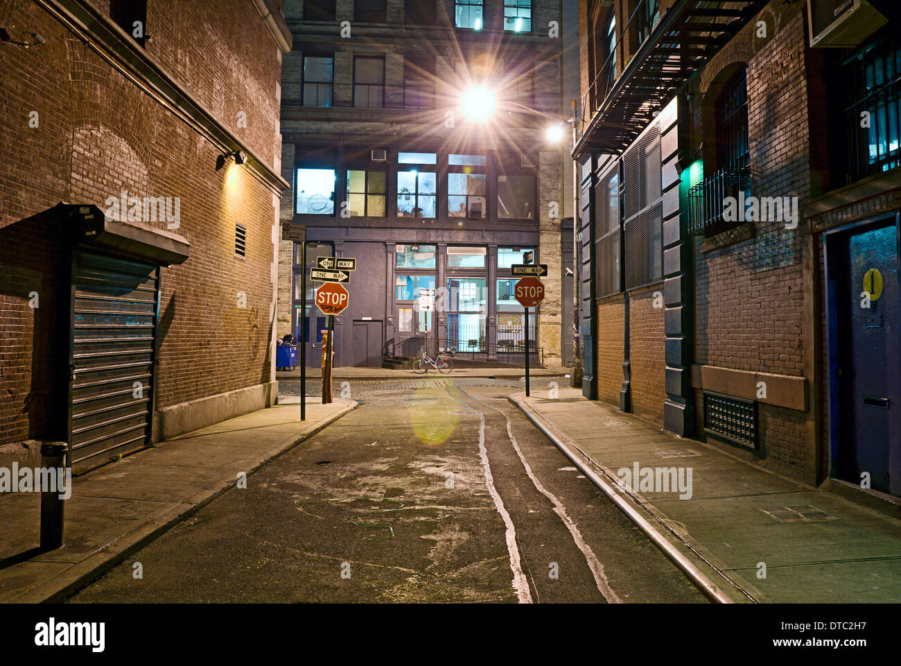 Deserted dangerous empty alleyway in urban industrial scene. Stock Photo