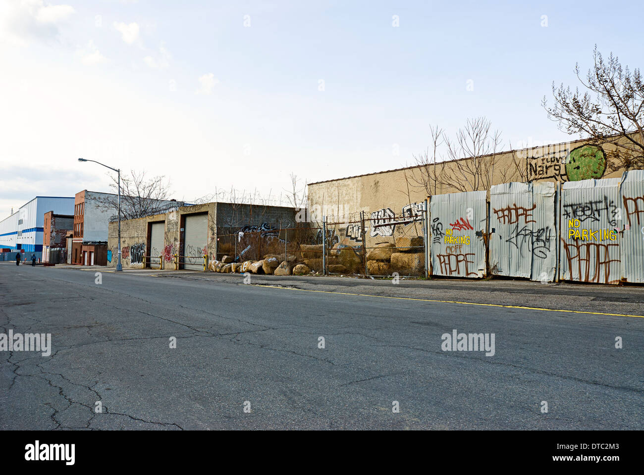 Deserted dangerous empty urban street scene with old warehouse buildings. Stock Photo