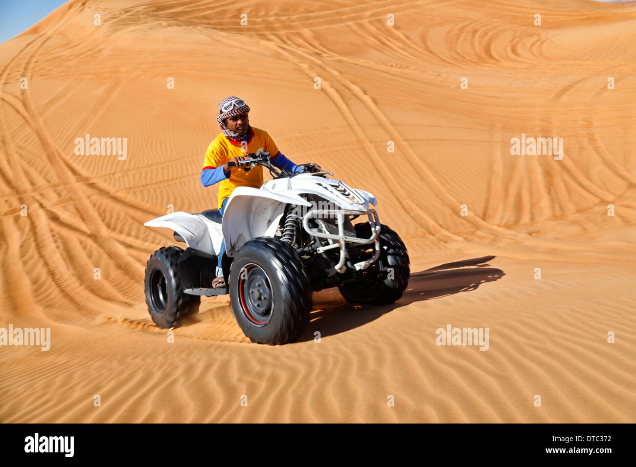 Quad driving in Dubai desert Stock Photo Alamy