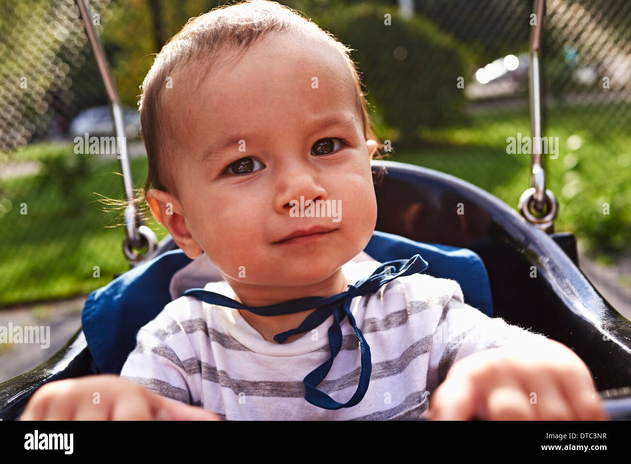 Baby boy sitting on swing hires stock photography and images Alamy