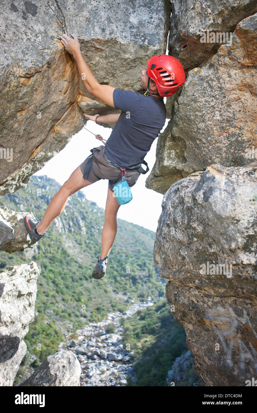 Young male rock climber balancing and holding rope Stock Photo