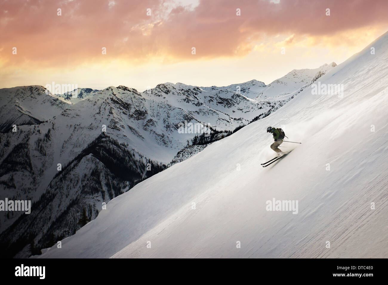 Mid adult man skiing down mountain, Golden, British Columbia, Canada Stock Photo