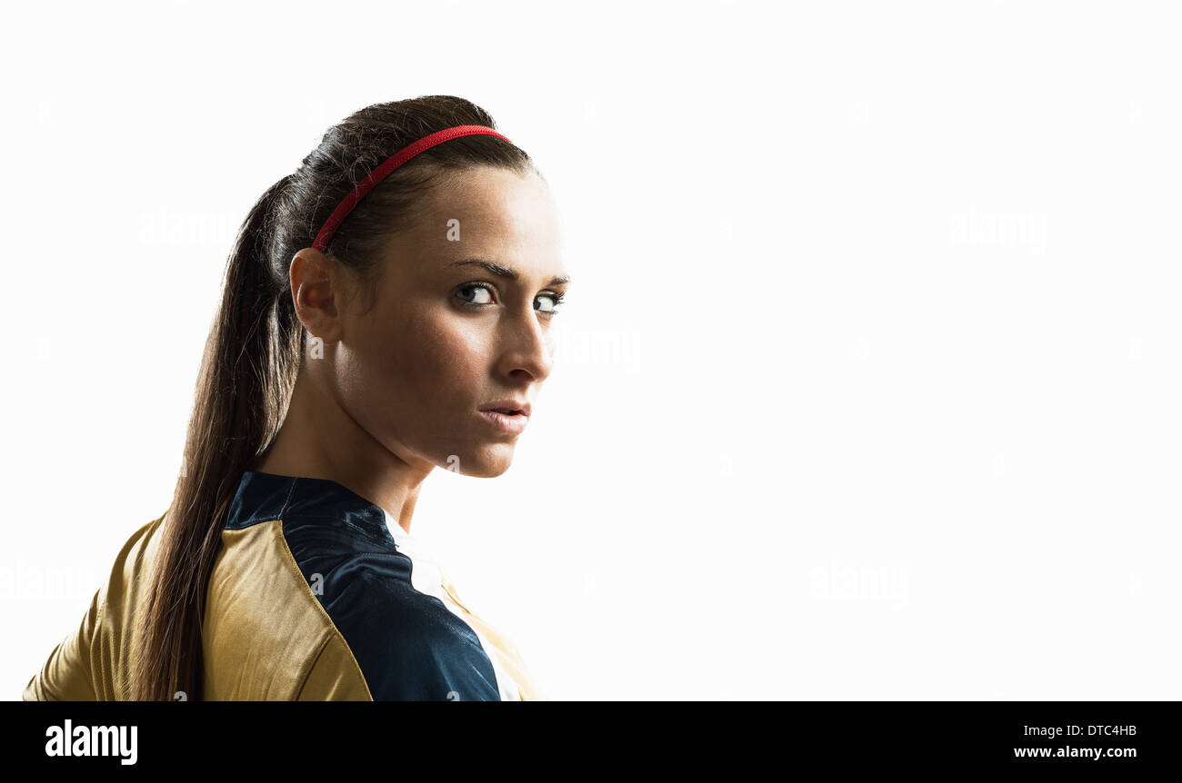 Studio portrait of young female soccer player Stock Photo