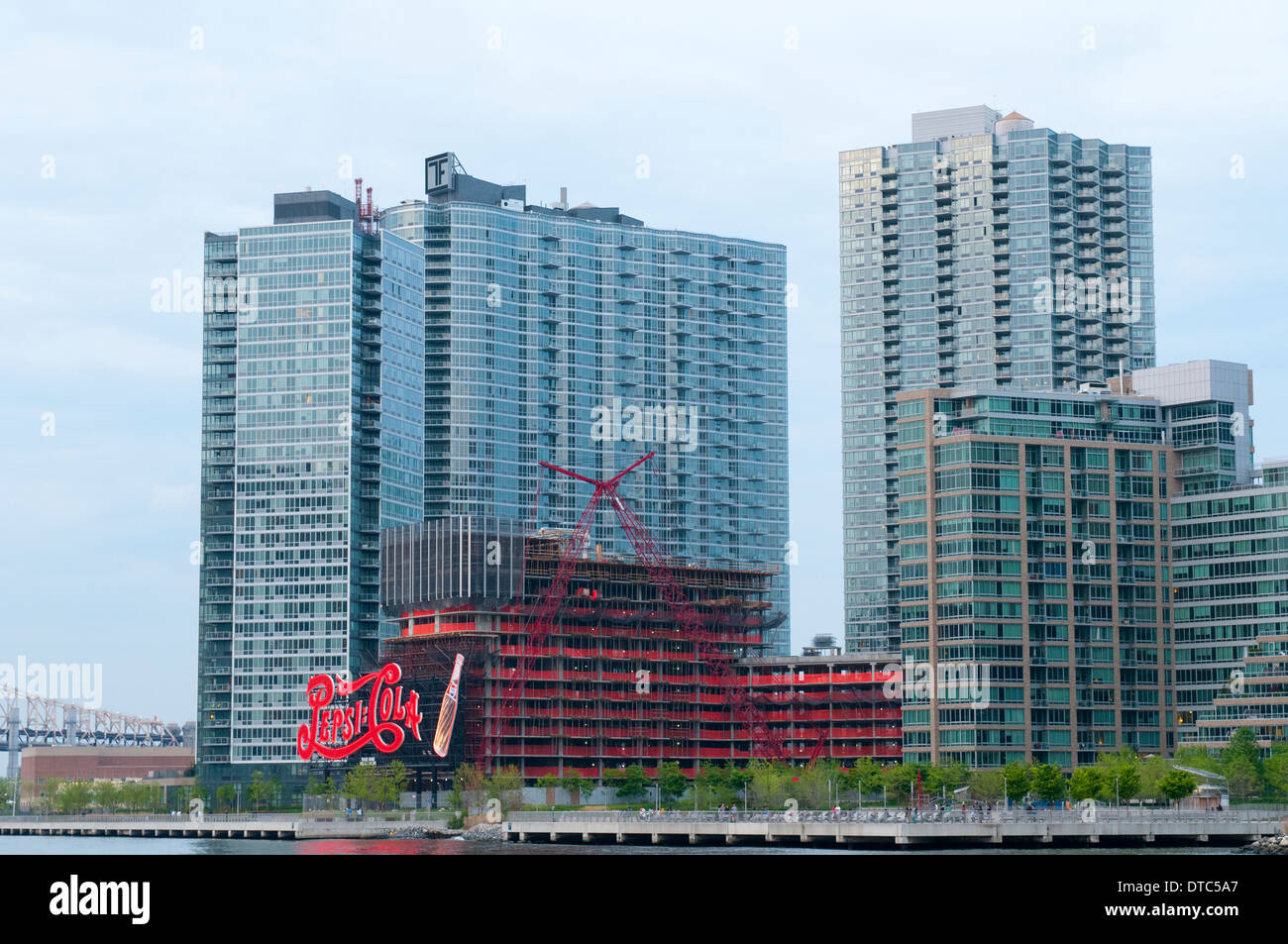Modern Apartment Buildings and a Pepsi Cola Sign viewed from the East River in New York City, USA Stock Photo