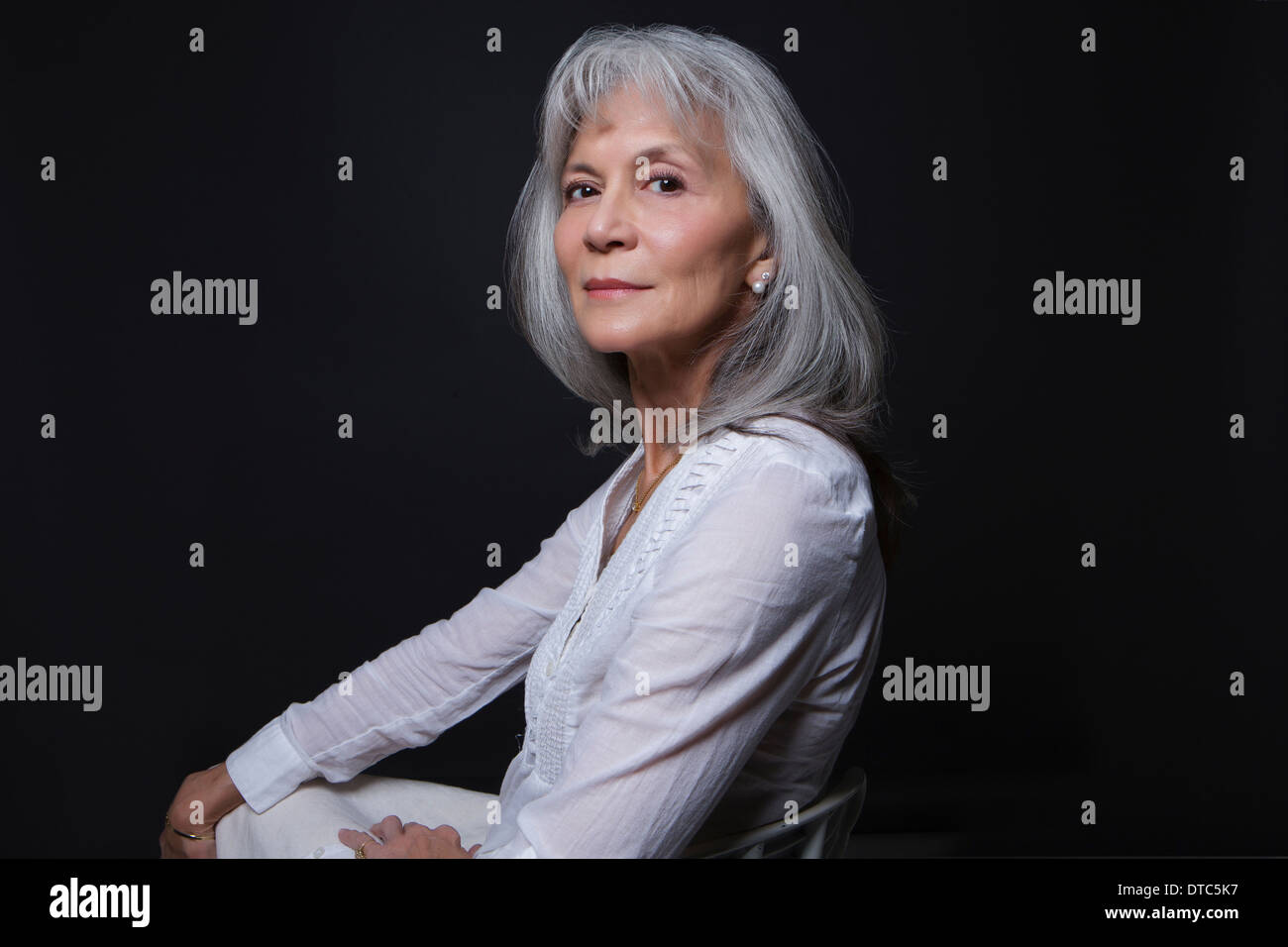 Studio portrait of aloof senior woman Stock Photo