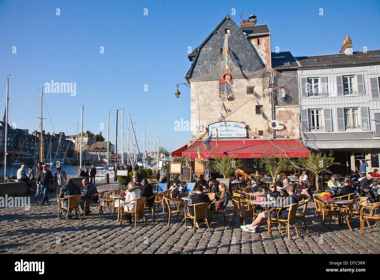 Outdoor terrace of the cafe La Maison Bleue beside the harbour in Honfleur, Normandy, France Stock Photo