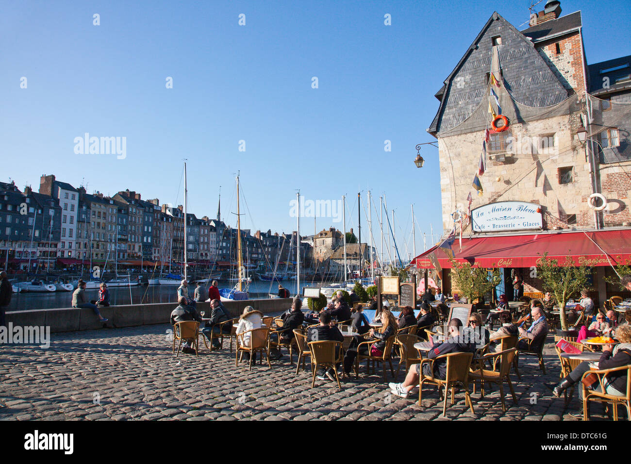 Outdoor terrace of the cafe La Maison Bleue beside the harbour in Honfleur, Normandy, France Stock Photo