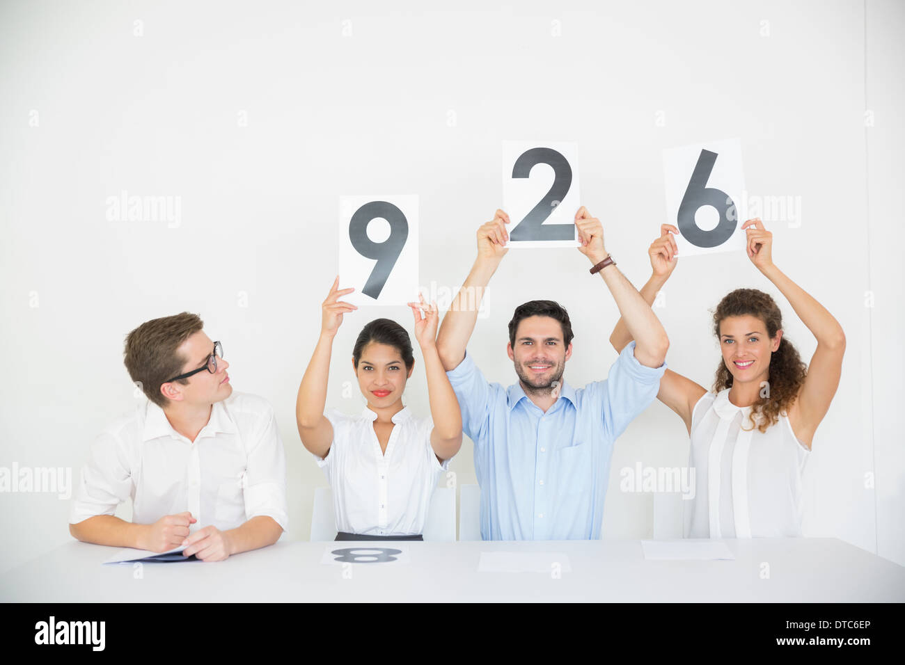 Business people holding score signs Stock Photo