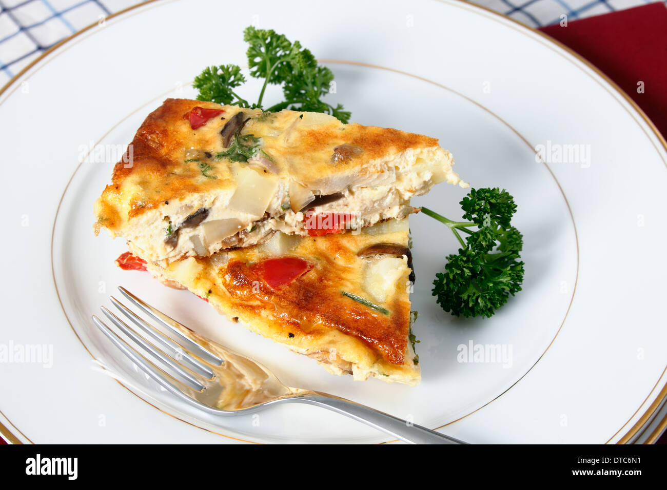Slices of Spanish omelette on a plate with a fork. Stock Photo