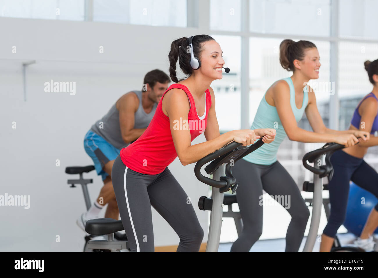 Fit people working out at spinning class Stock Photo - Alamy