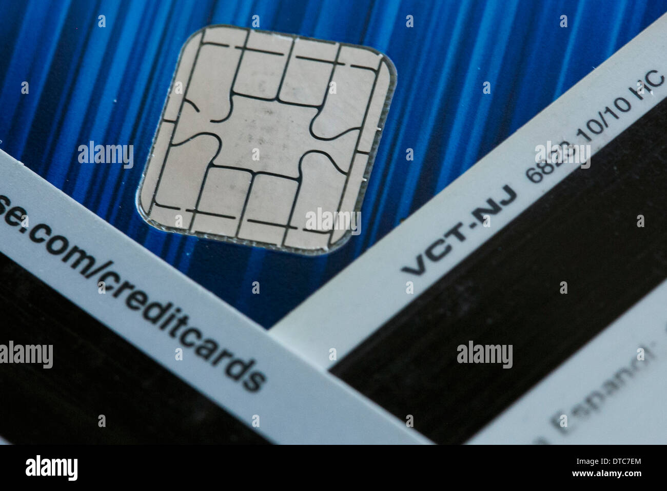 A Visa credit card featuring an EMV chip, also known as 'chip and PIN' juxtaposed with a magnetic strip card. Stock Photo