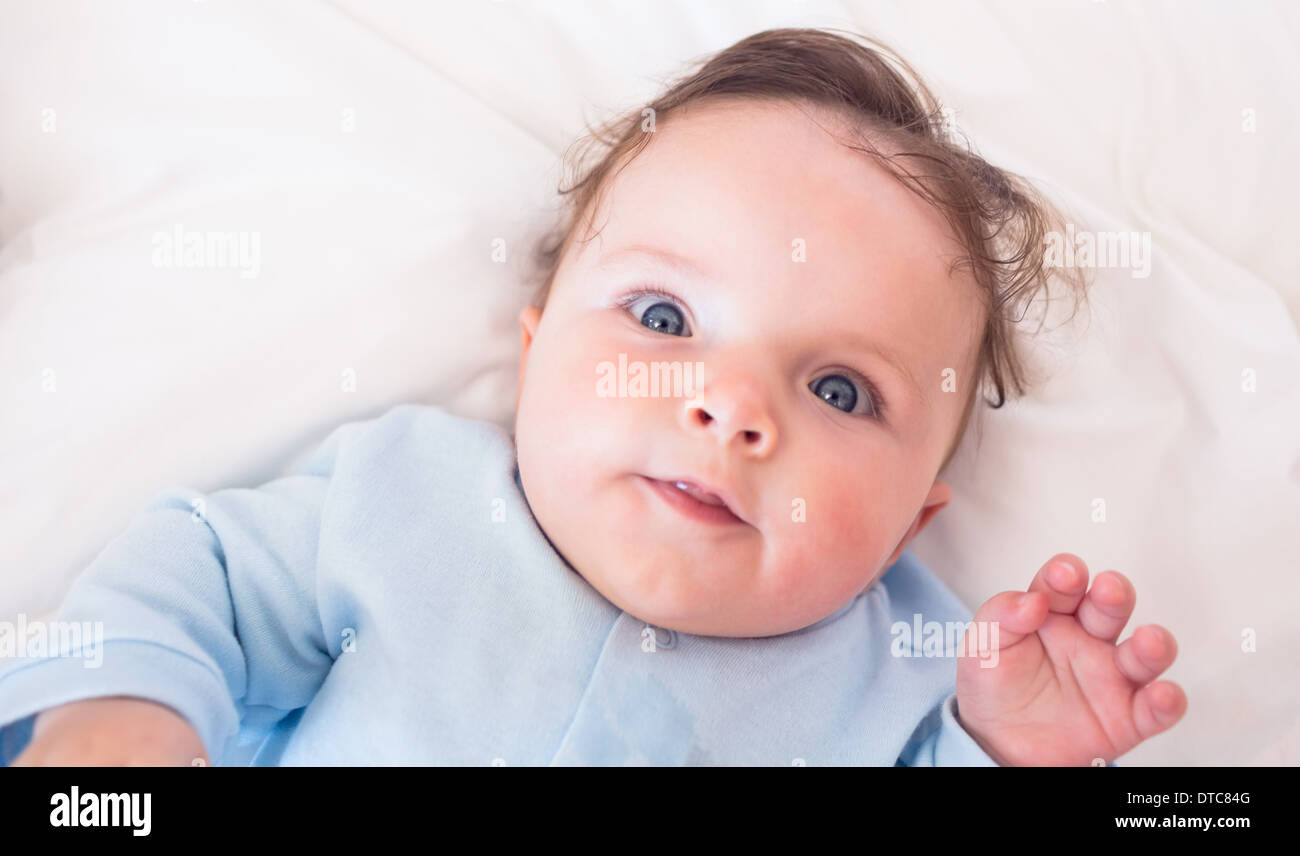 Lovely baby boy lying in bed Stock Photo