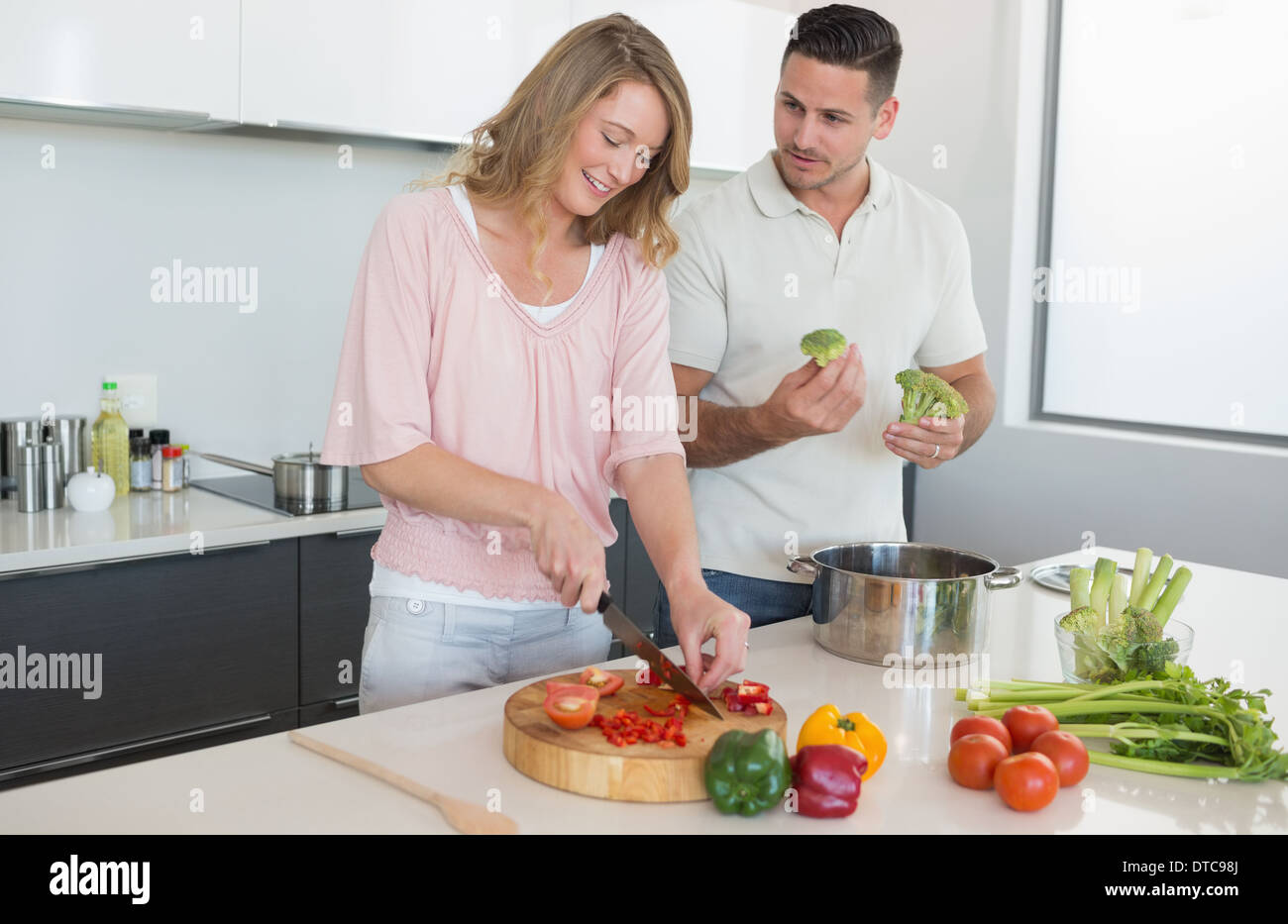 Couple preparing food in kitchen Stock Photo