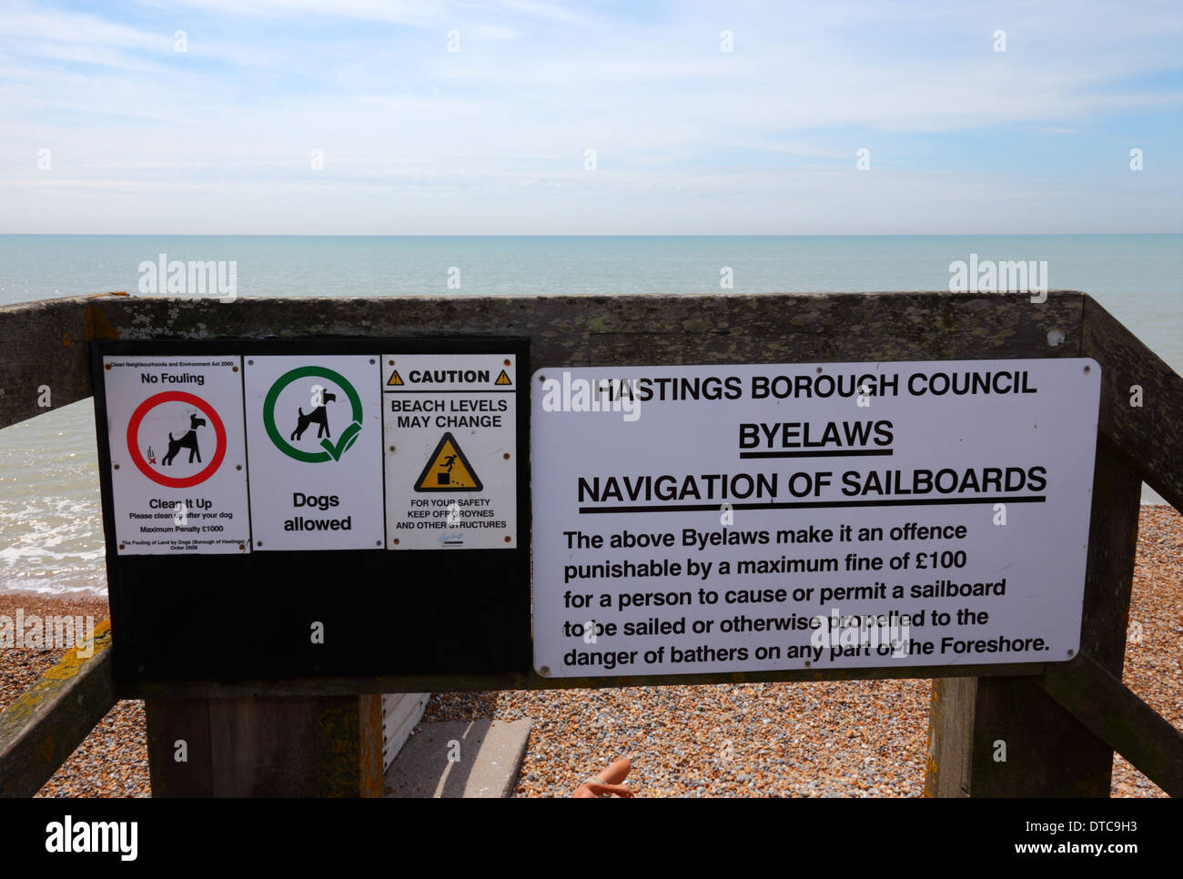 Dogs allowed, no dog fouling, beach levels may change and byelaws for using sailboards signs on beach access point, St Leonards on Sea, East Sussex Stock Photo