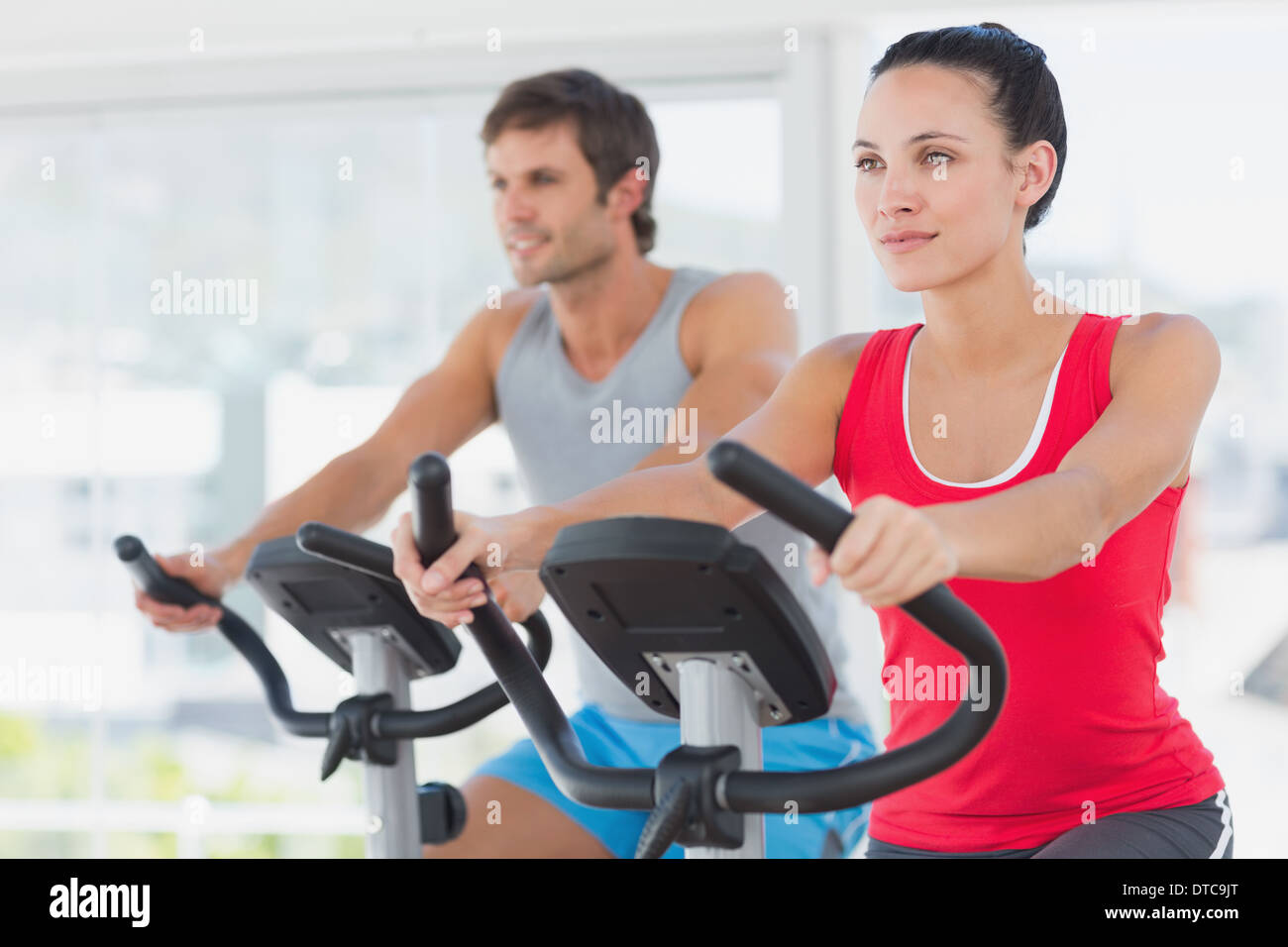 Determined couple working out at spinning class in gym Stock Photo - Alamy