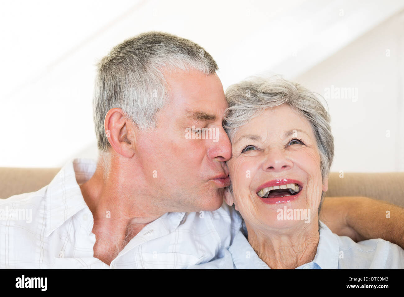 Senior man kissing happy wife Stock Photo