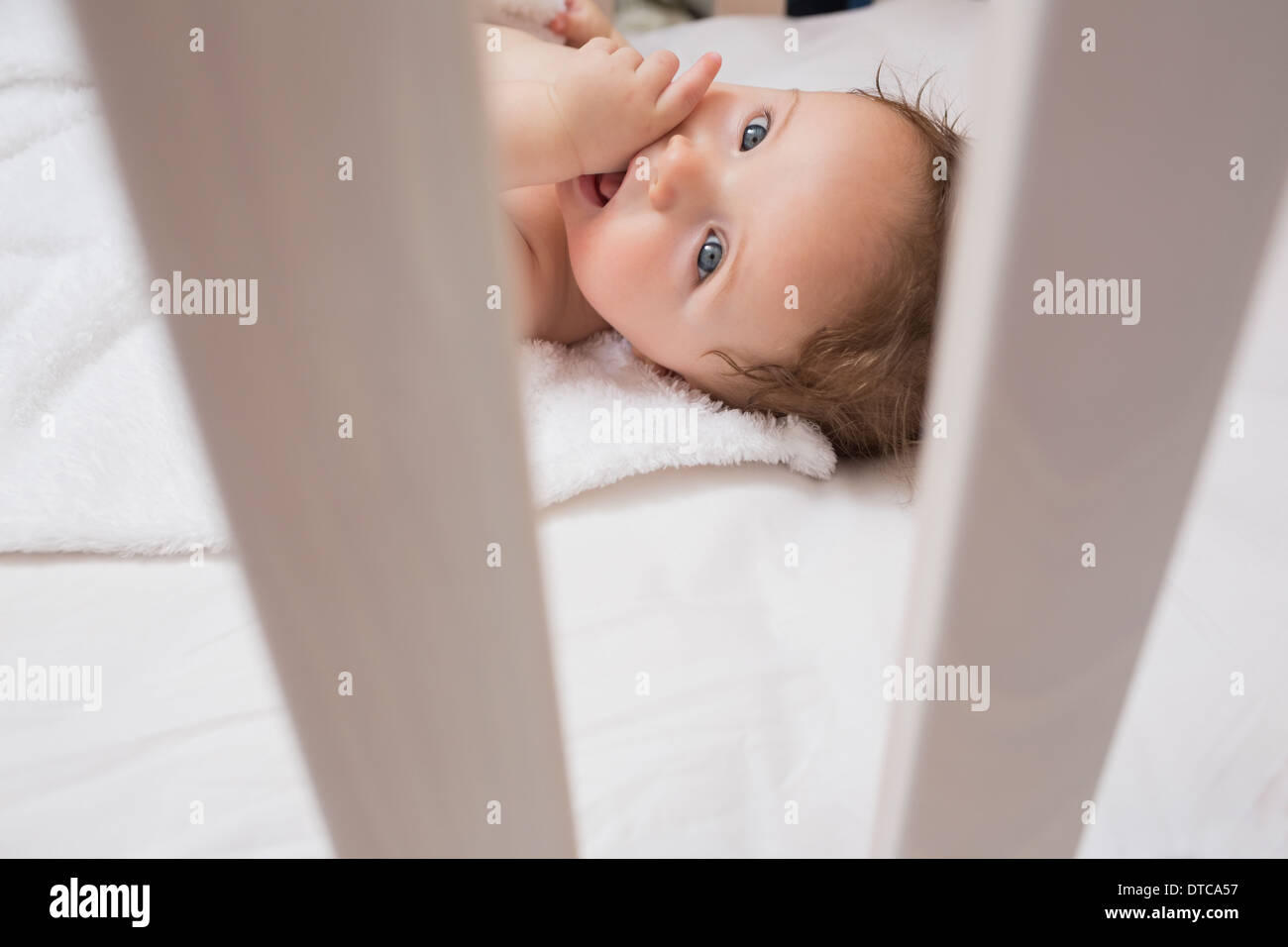 Lovely baby with finger in mouth Stock Photo