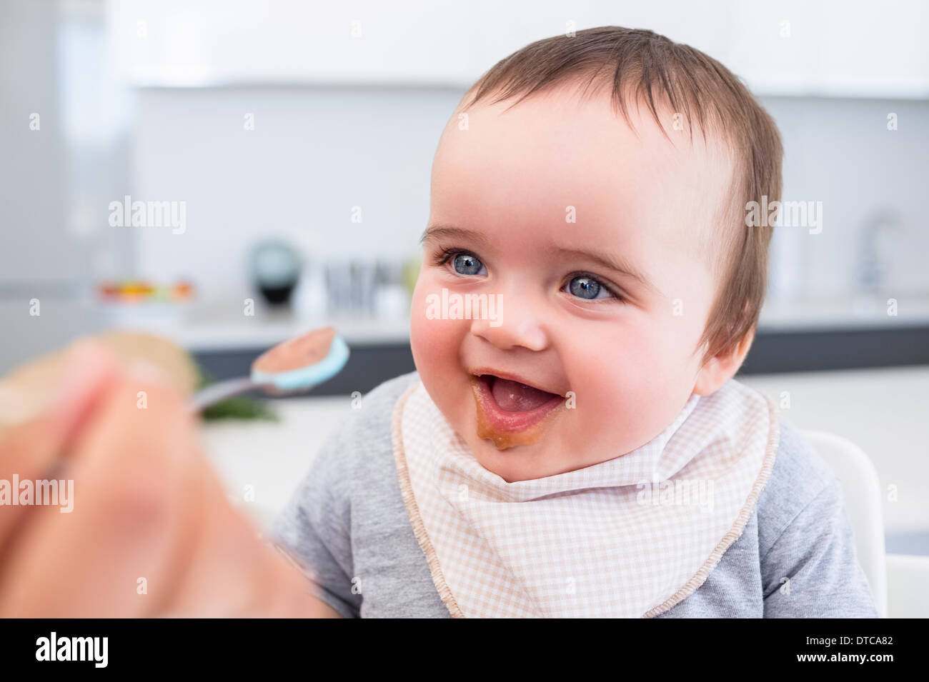 Baby boy being fed by mother Stock Photo
