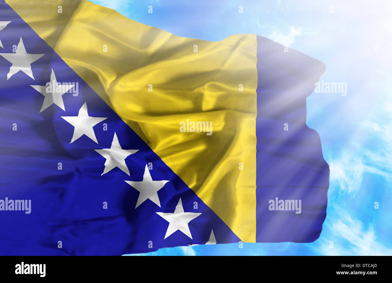 Bosnia and Herzegovina waving flag against blue sky with sunrays Stock ...