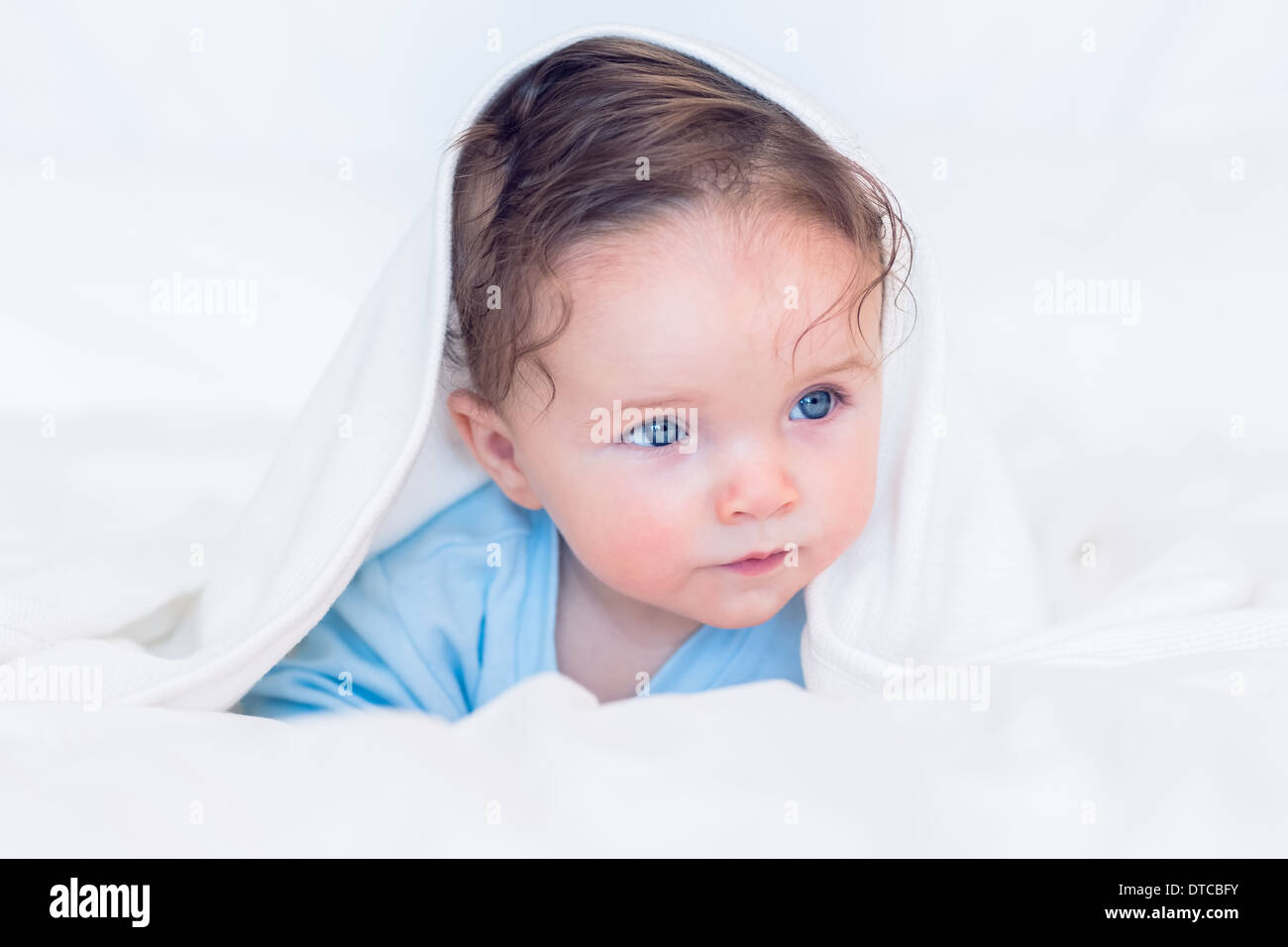 Baby covered in blanket Stock Photo Alamy
