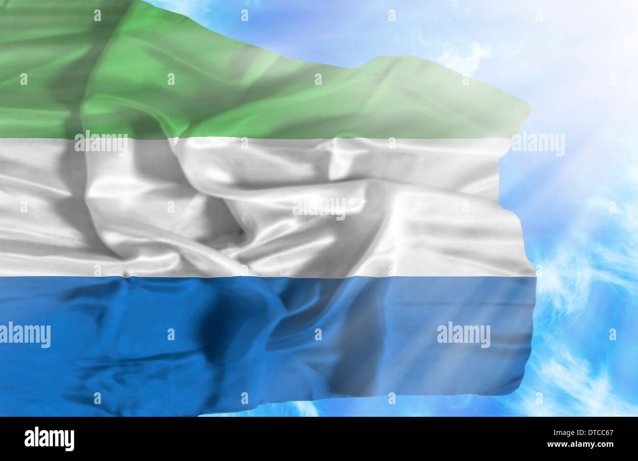 Sierra Leone waving flag against blue sky with sunrays Stock Photo - Alamy