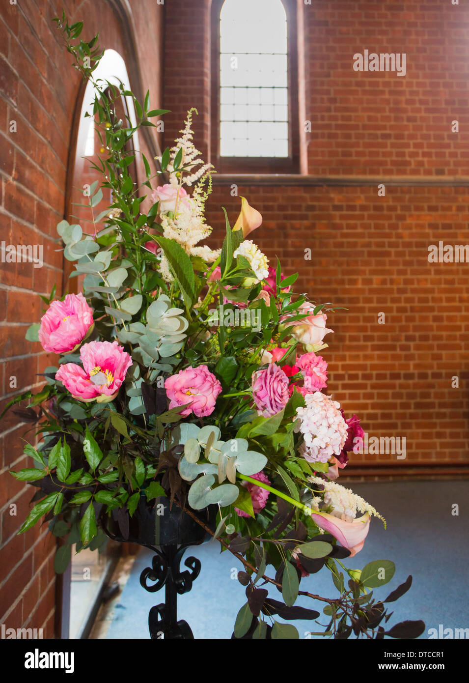 Flower arrangement as a selfstanding floral display of pink and red
