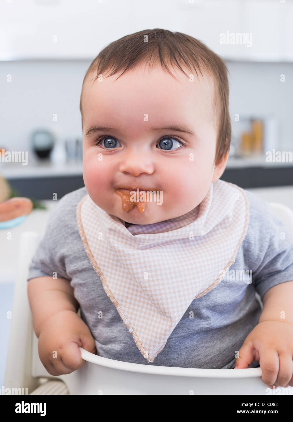 Messy baby eating food Stock Photo