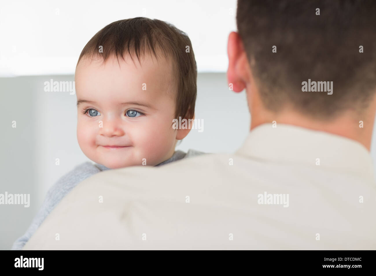 Baby being carried by father Stock Photo