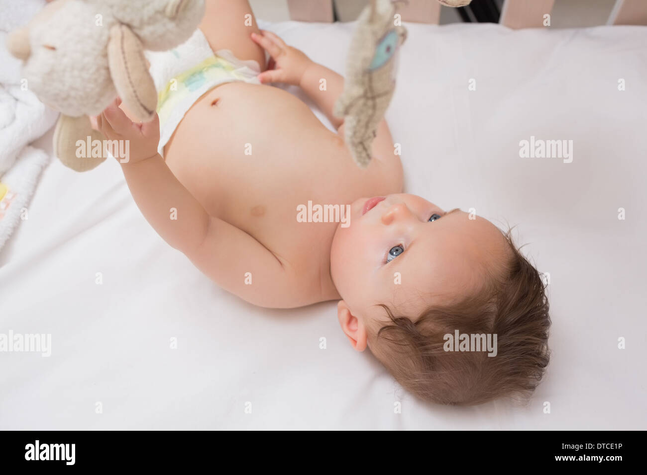 Cute baby lying in crib Stock Photo