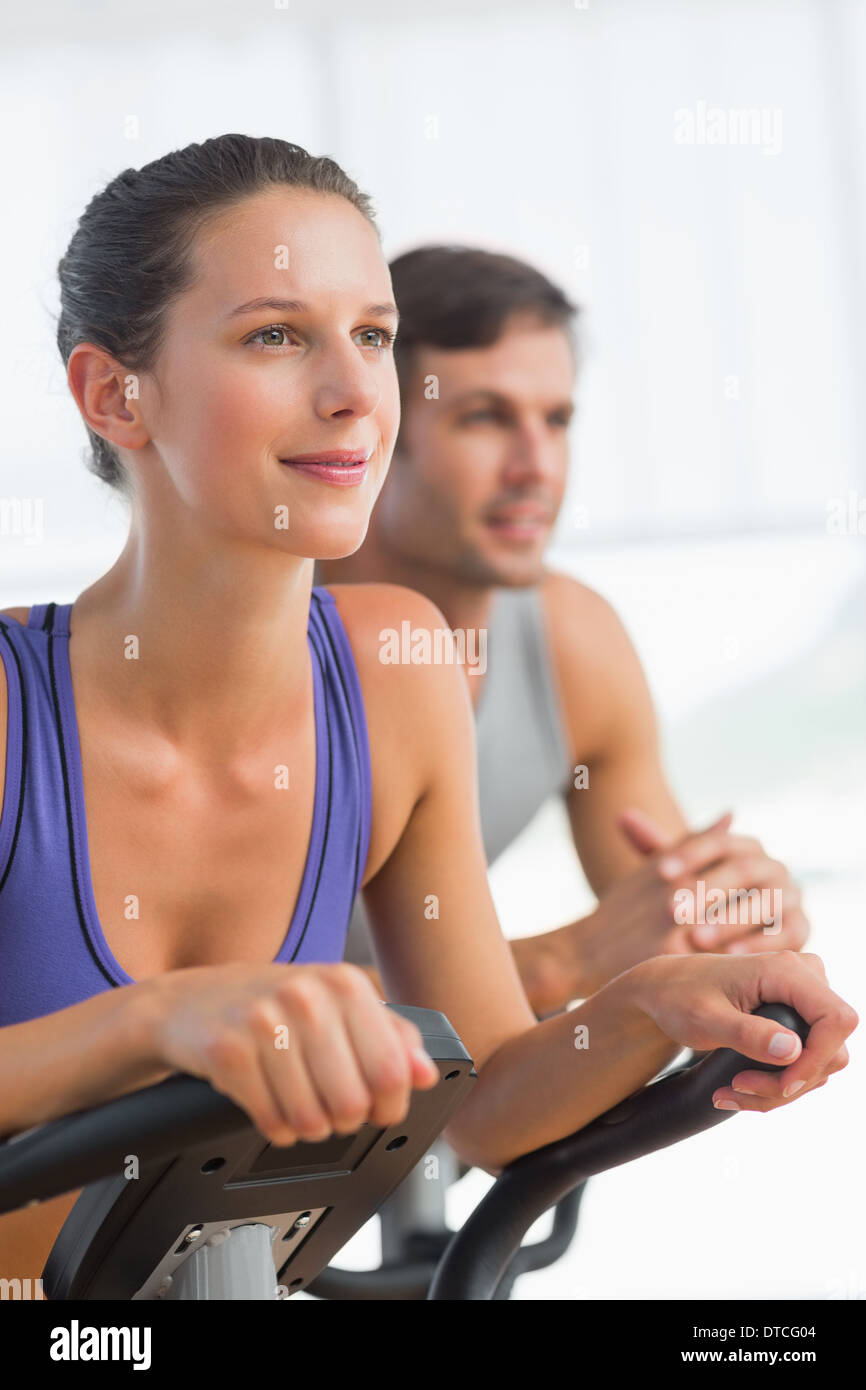 Smiling young couple working out at spinning class Stock Photo