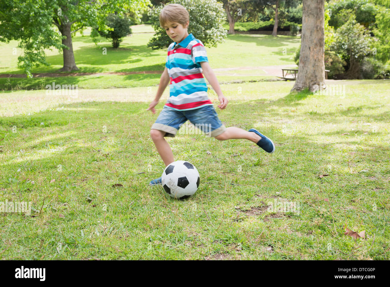 Child kicking a ball hires stock photography and images Alamy