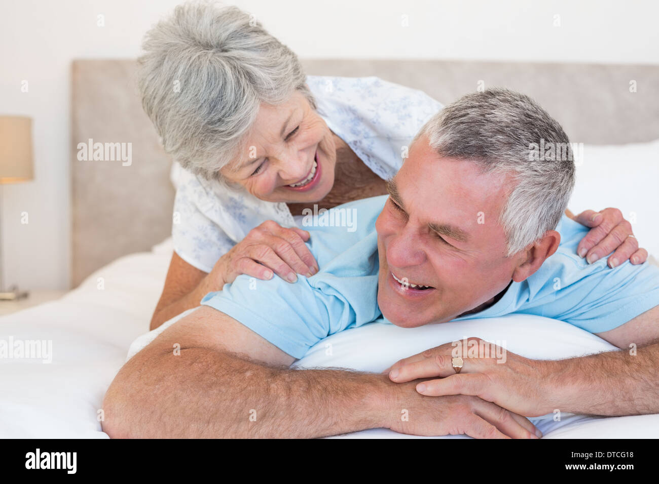 Senior couple lying in bed Stock Photo
