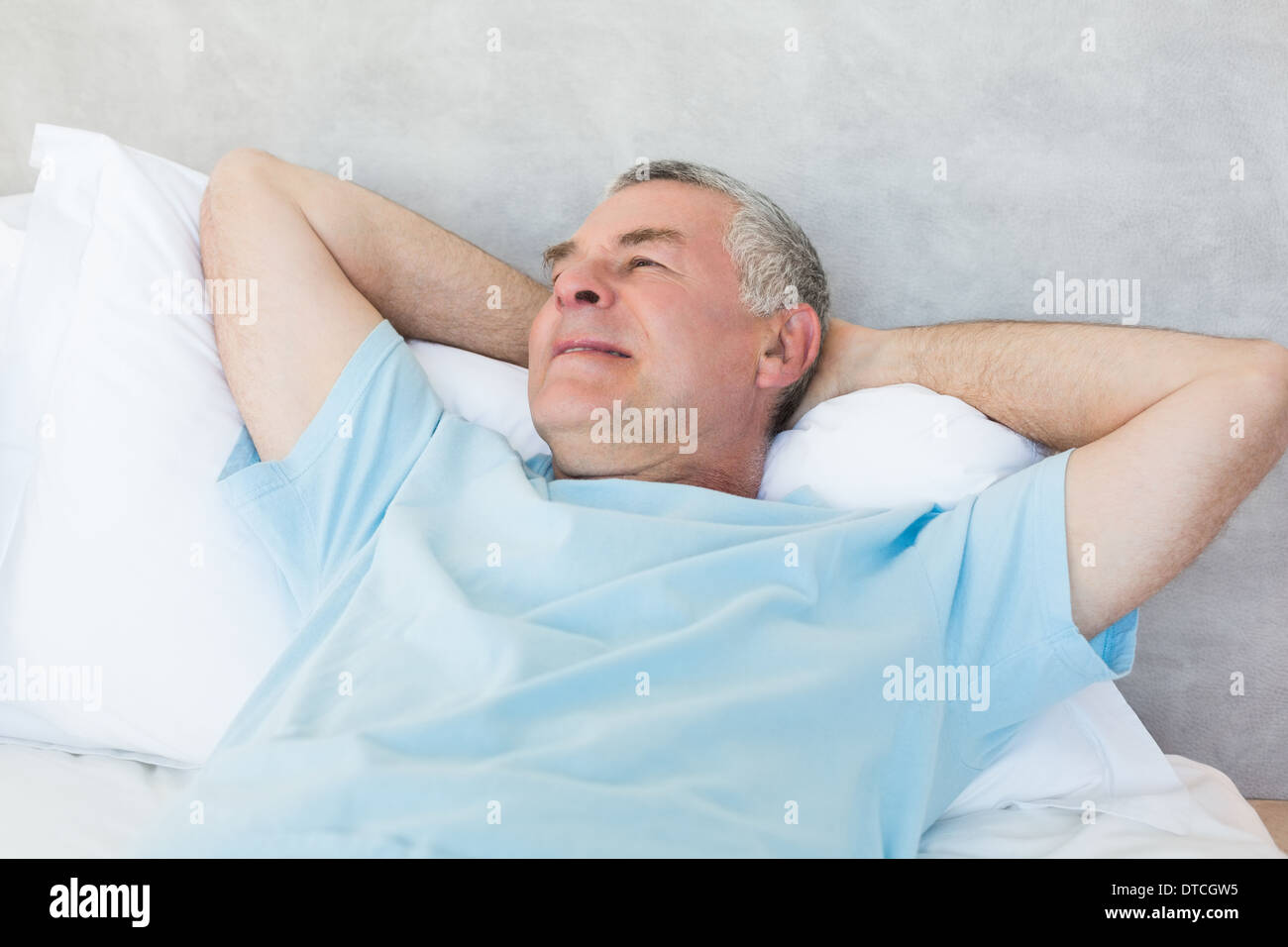 Senior man day dreaming in bed Stock Photo Alamy