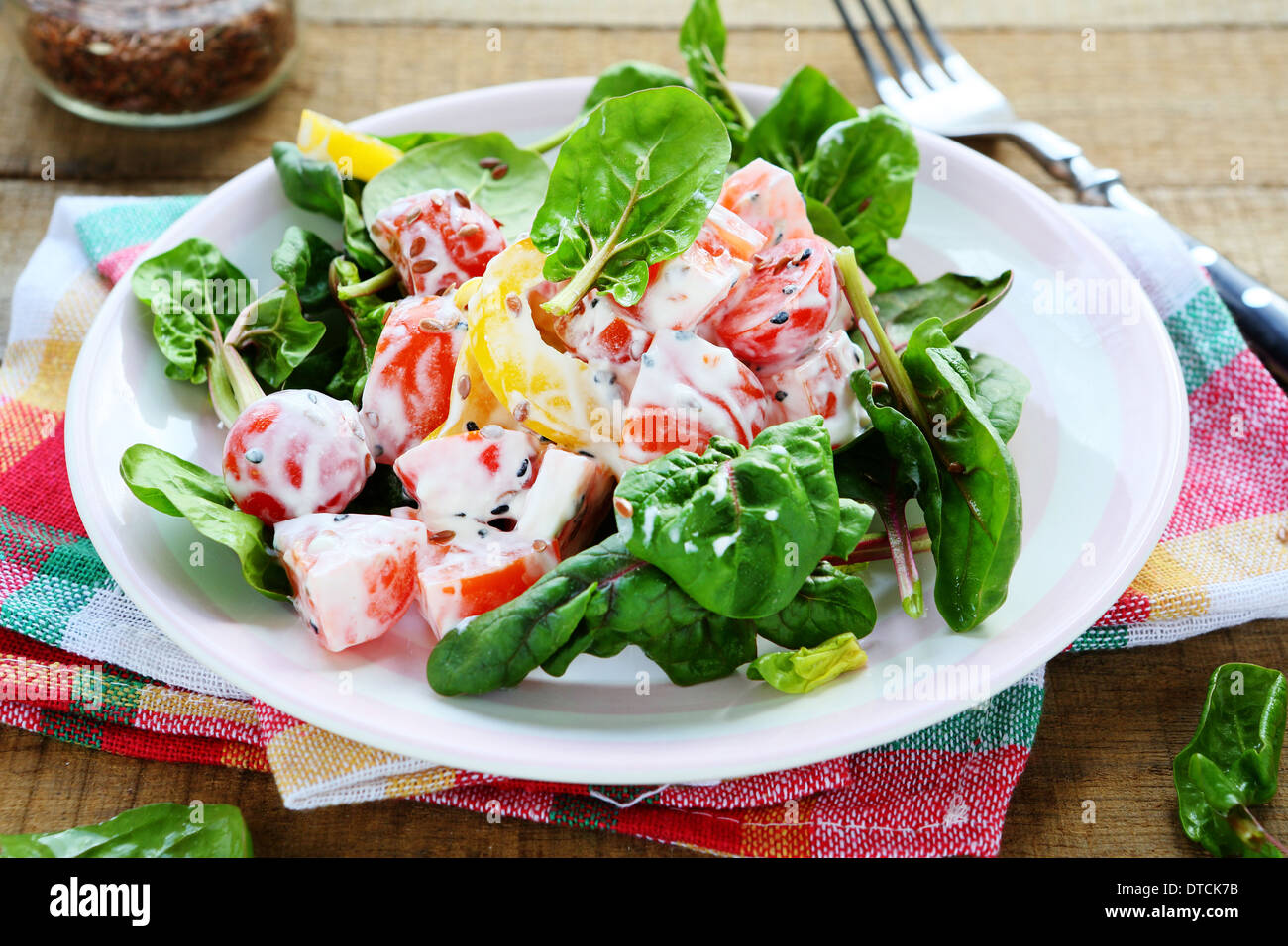 fresh salad with tomatoes, peppers and yogurt, food Stock Photo
